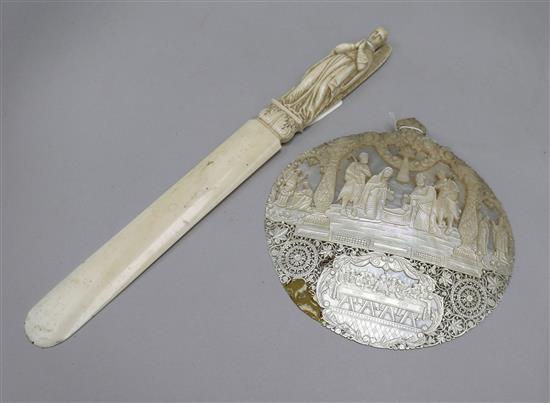 A 19th Century arch-angel Ivory page turner and a carved mother of pearl nativity panel, possibly Macau 39cm